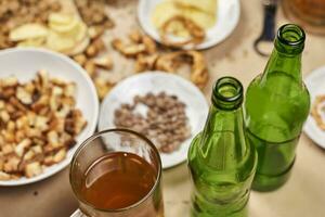 Drinking beer. Table full of beer snacks photo