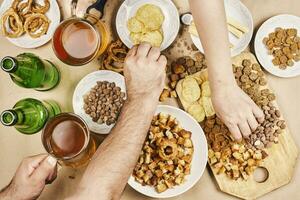 Drinking beer. Table full of beer snacks photo