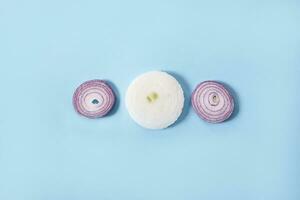 Onion rings on blue background photo