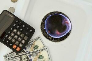 Burning gas stove burner, calculator and money photo