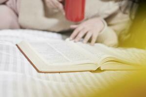 A young woman drink coffee and read book photo