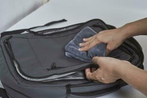 Cleaning backpack with washcloth photo