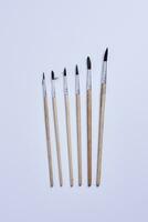 Various size painting brushes on white photo