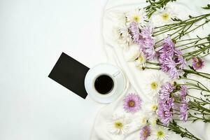 A cup of coffee with fresh spring flowers photo