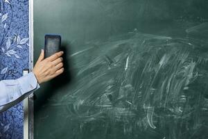 Teacher cleans chalkboard photo