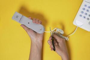 A man cuts a cable from the phone photo