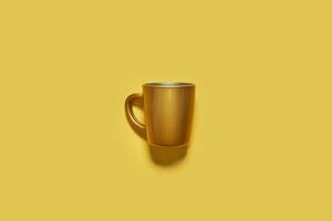 Golden drink cup on yellow background photo