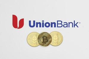 Bitcoin and ethereum cryptocurrency coins on Union Bank logotype photo