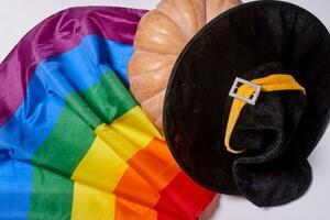 LGBTQ rainbow flag and big orange pupmkin photo