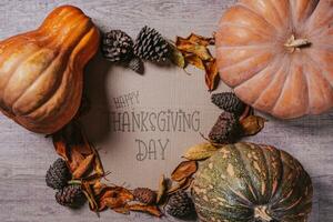 Happy thanksgiving day - Autumnal background with harvest fall vegetables and autumnal leaves photo