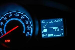 Automobile dashboard in neon light at night photo