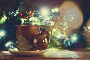 Golden Xmas bells, coffee cup and cookie photo