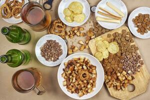 Drinking beer. Table full of beer snacks photo