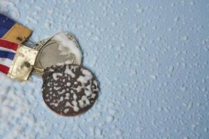 Olympic medals on bright background photo