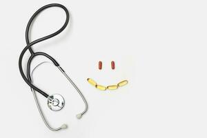 Stethoscope and smile sign made of pills photo