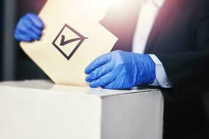 A person in medical gloves voting photo
