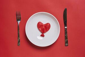 Eating love. Heart shape balloon eating photo