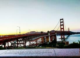 California, San Francisco, USA - 08.23.2023 View of the famous Golden Gate Bridge in the sunset rays of the sun. photo