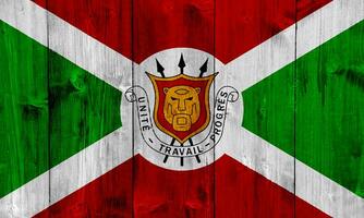 bandera y Saco de brazos de república de Burundi en un texturizado antecedentes. concepto collage. foto