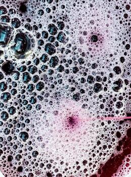 The process of making homemade grape wine. The operation of a hydraulic press to obtain grape juice for fermentation. Close-up of freshly squeezed grape juice photo