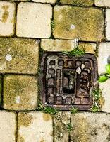 Manhole cover of the gas pipeline system. A massive metal hatch for access to city communications in the pavement. photo