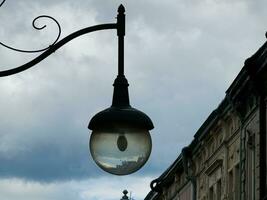 Retro lantern on the background of the blue sky. vintage lantern. A street lantern. Reflection on the surface of the lamp. photo