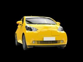 Yellow compact urban car on black background - closeup shot photo