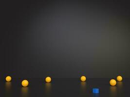 Yellow balls and a single blue cube on dark bacground photo