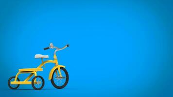 Pretty vintage yellow tricycle - blue background photo