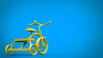 Bright yellow tricycle on blue background photo