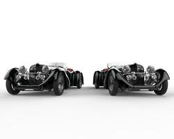 Two black vintage cars - front view photo