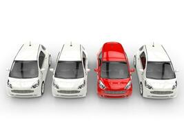 Row of compact cars - red stands out - top view photo