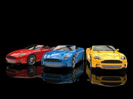 Convertible sports cars - primary colors - on black reflective background photo