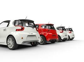 Row of compact cars - red stands out - back perspective view photo