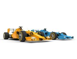 Yellow and blue formula one cars - isolated on white background photo