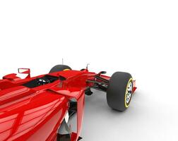 Red formula one car - focus on front wheels - isolated on white background. photo