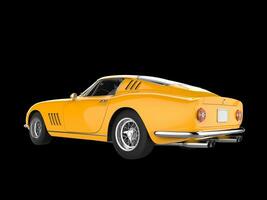 Vintage yellow sports car - back side view - isolated on black background photo