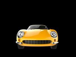 Vintage yellow sports car - front view closeup shot - isolated on black background photo