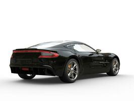 Pitch black sports car - back view - isolated on white background photo