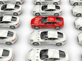 Rows of beautiful sports cars - red car stands out amongst white ones - top view photo