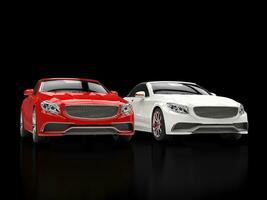 Red and white modern cars on black reflective background photo