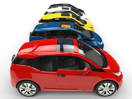 Row of small electric cars - various colors - side view photo