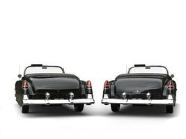 Two awesome black vintage cars - back view photo