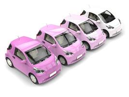 Row of cool urban modern compact cars in shades of pink photo