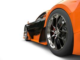 Black and orange supercar - rear wheel shot - 3D Render photo