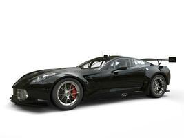 Jet black awesome sportscar - studio shot photo