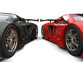 Black and red awesome supercars side by side - wheels closeup shot photo