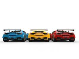 Modern luxury sportscars in red, yellow and blue colors - back view photo