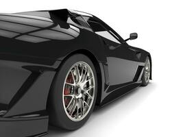 Pitch black modern sports car - rear wheel closeup shot photo