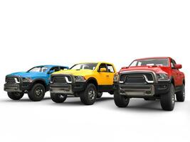 Red, blue and yellow modern pick-up trucks - studio shot photo